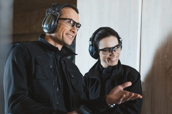 A shooting range instructor practicing etiquette with a student | father's day